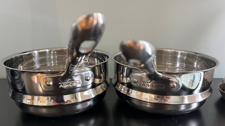 A pair of All-Clad stainless steel saucepans