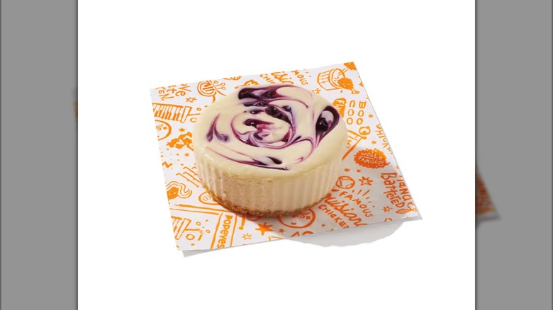 Popeyes Blueberry Lemon Cheesecake Cup on top of paper square with orange design