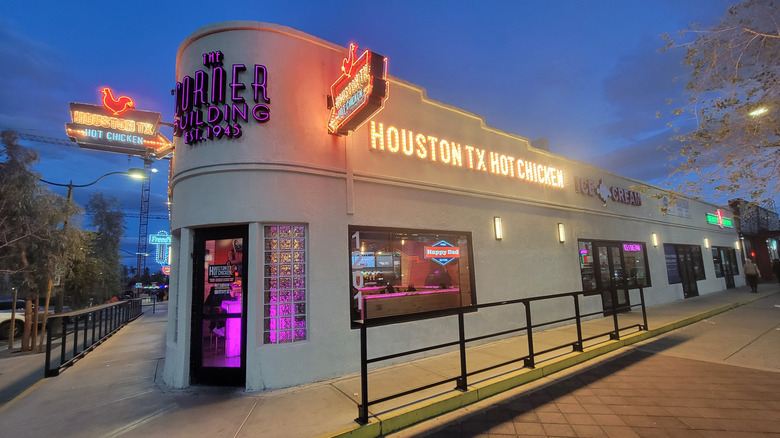 Houston TX Hot Chicken sign lit up at dusk