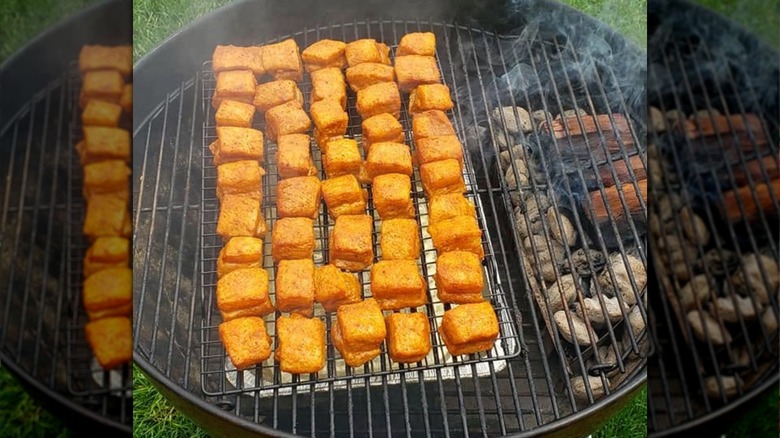Pork belly ends on a grill with cherrywood chunks