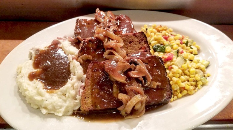 Cheesecake Factory Famous Factory Meatloaf with mashed potatoes, corn, mushrooms, and gravy on white plate