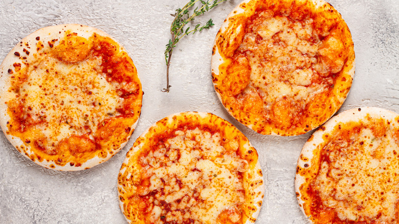 Four small personal margherita pizzas