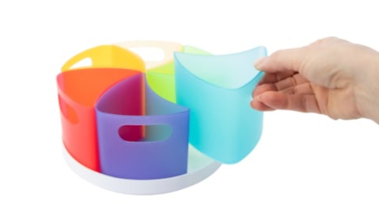 Hand removing bucket from rotating organizer
