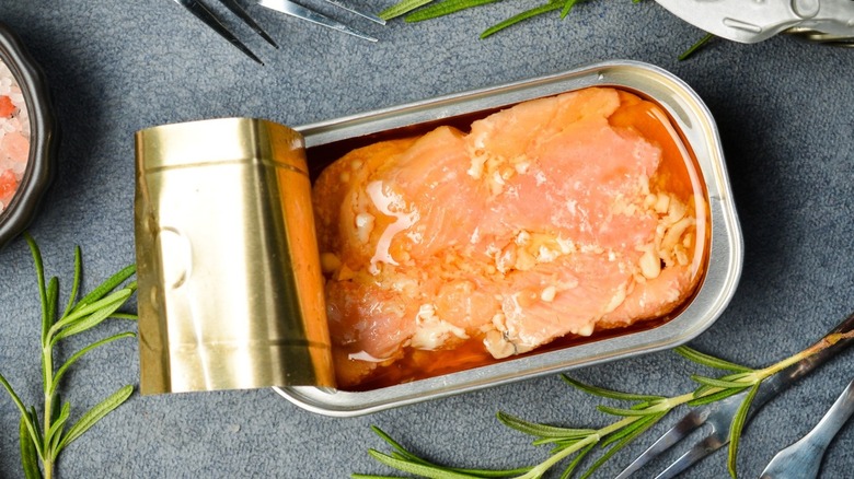 tinned salmon with rosemary on a table