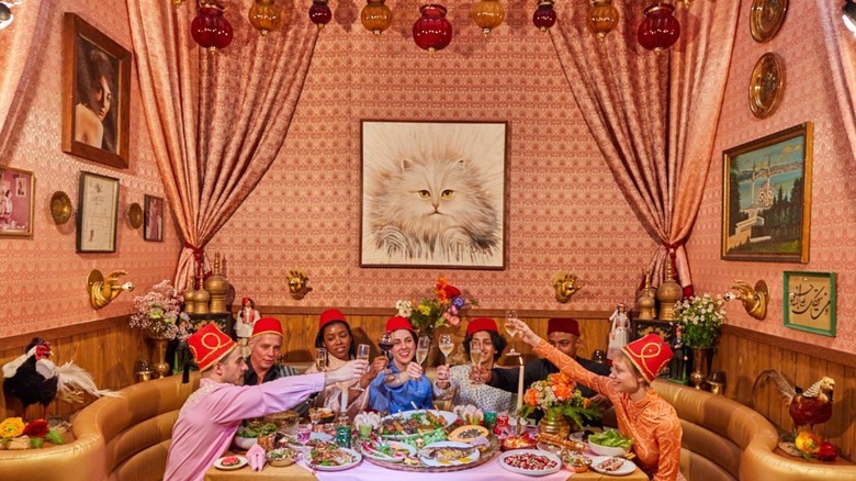 A large, festive group at Turk's Inn, in front of the cat portrait