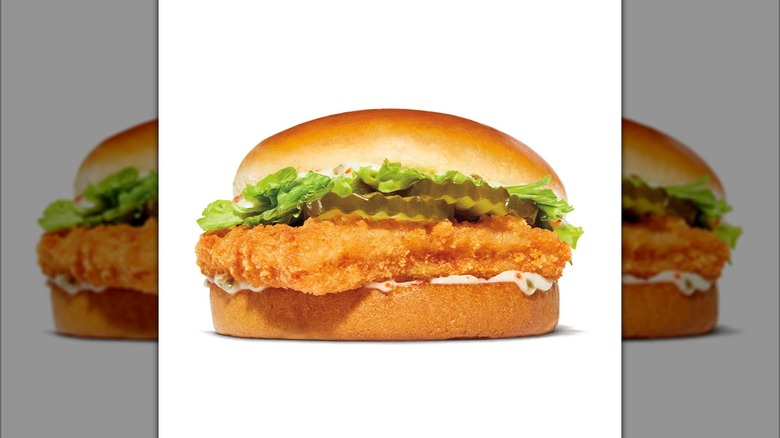 Burger King Big Fish sandwich with lettuce, pickles, and tartar sauce on white background