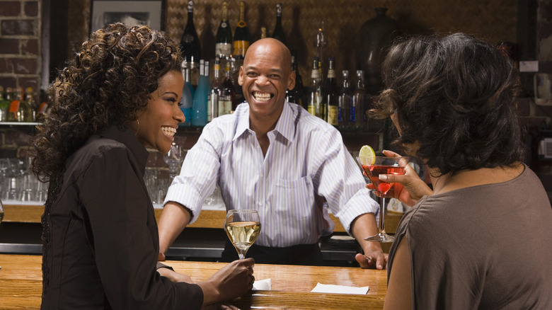 Bartender talking with customers