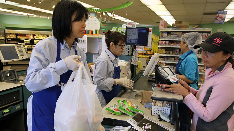 A cashier and customer at a Japanese market