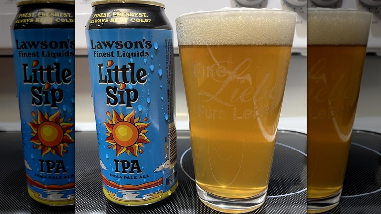 A blue can of Lawson's Little Sip IPA next to a pint glass full of a light golden liquid with a strong head of bubbles.