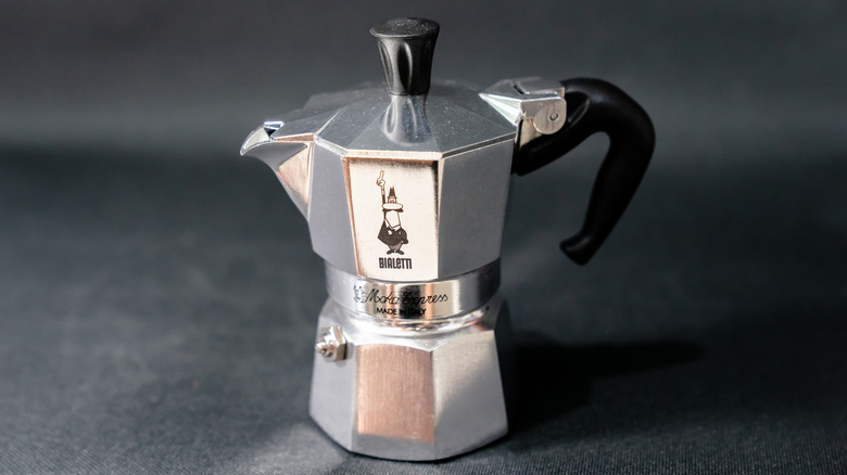 An aluminum Bialetti Moka Express against a gray backdrop