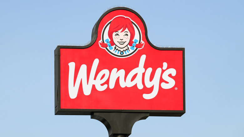 Red Wendy's sign against blue sky