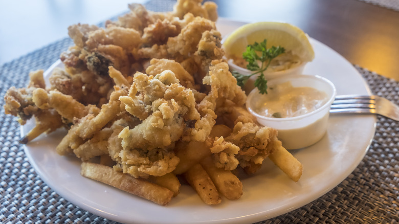 Deep fried clams on white plate