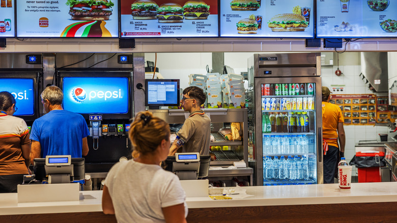 Close up view of Burger King counter with customer waiting