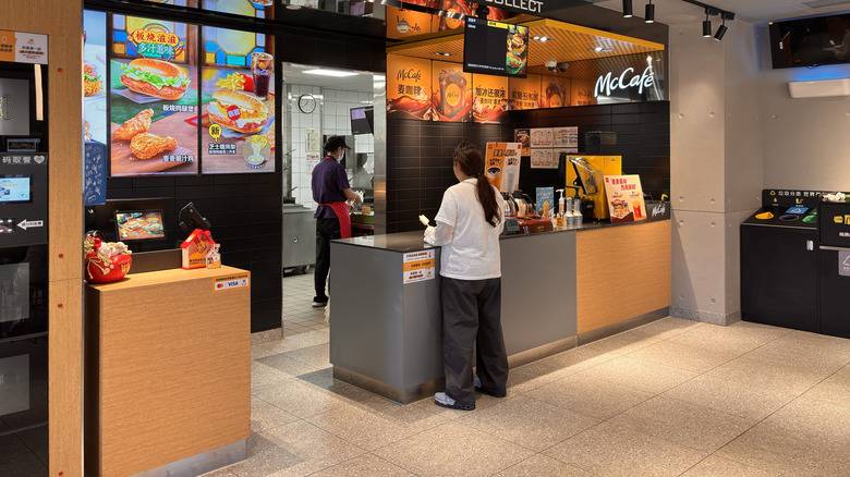 Customer waiting at counter in empty McDonald's