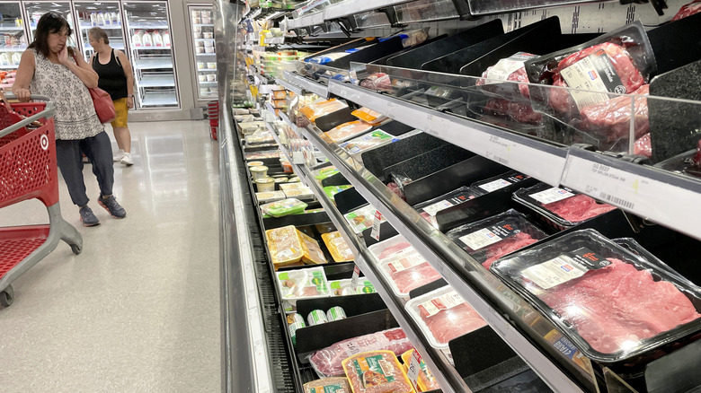 Customers shop for meat at Target.