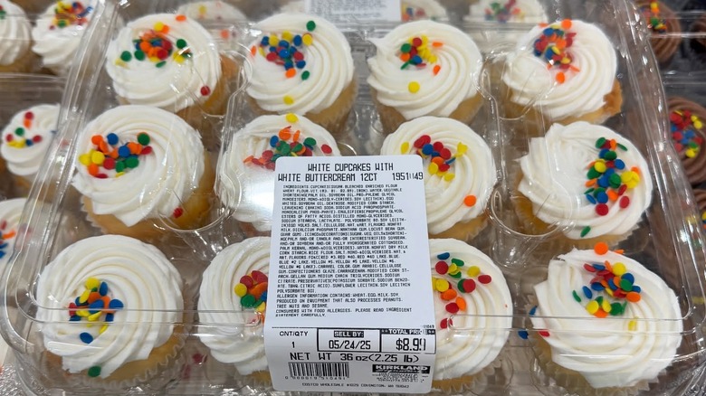 Plastic package of white cupcakes with white buttercream topped with sprinkles