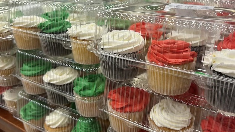 Assorted chocolate and vanilla cupcakes topped with buttercream in plastic packages