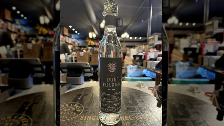 Bottle of Don Fulano on a wooden table in a retail store