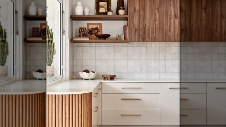 kitchen corner with white hand-made Moroccan tiles, open shelving and styled decor items