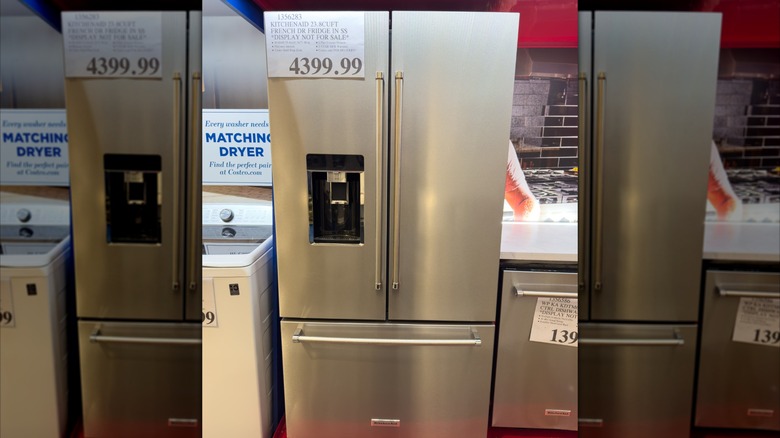 A mirrored image Kitchenaid French Door fridge in stainless steel on display inside a Costco warehouse