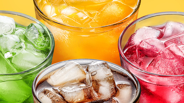 Colorful sodas in glasses with ice