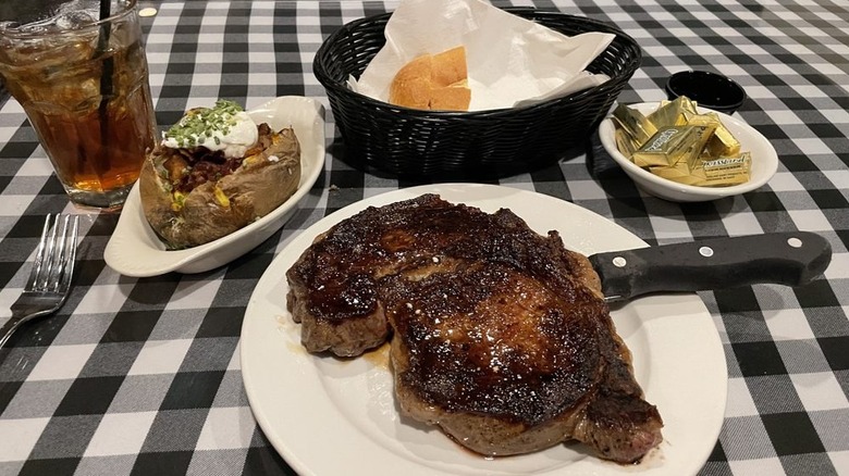 steak on a plate surrounded by sides at Linda's La Cantina