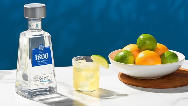 Bottle of 1800 tequila blanco with cocktails