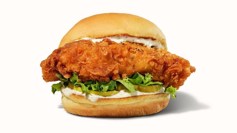 Crispy chicken sandwich with lettuce, pickles, and creamy sauce