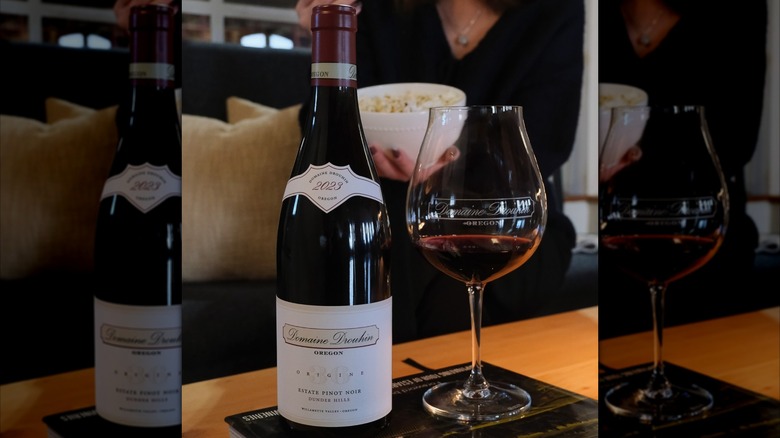 A bottle of Domaine Drouhin red wine with a glass