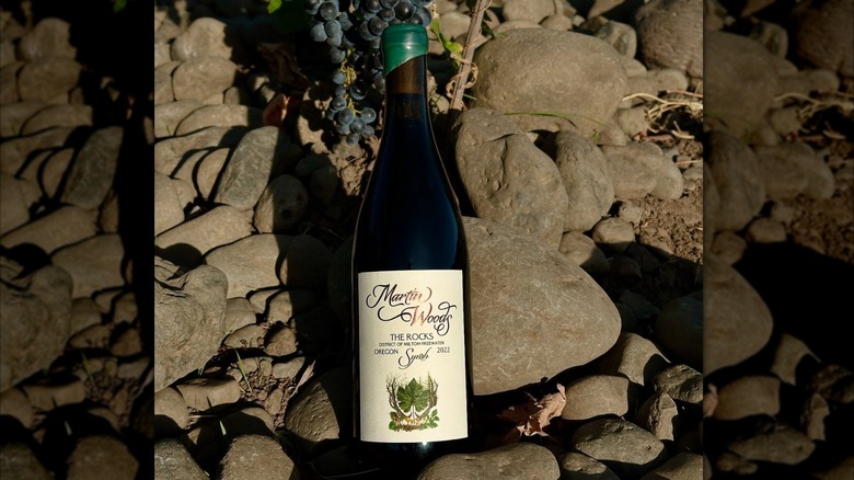 A bottle of Martin Woods Rocks Syrah red wine lying on rocks
