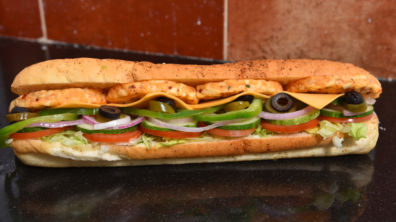 Footlong Subway sandwich on black countertop