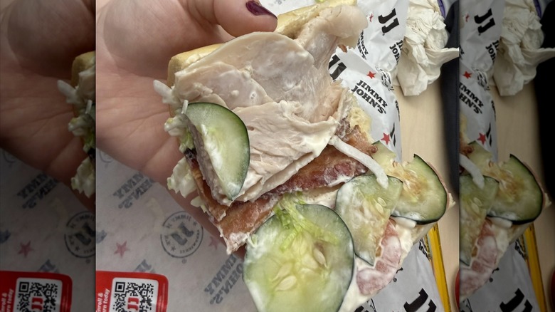 hand holding open Club Lulu sandwich, mirrored image