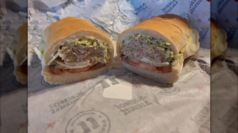 two halves of Club Tuna sandwich on Jimmy John's packaging, mirrored image