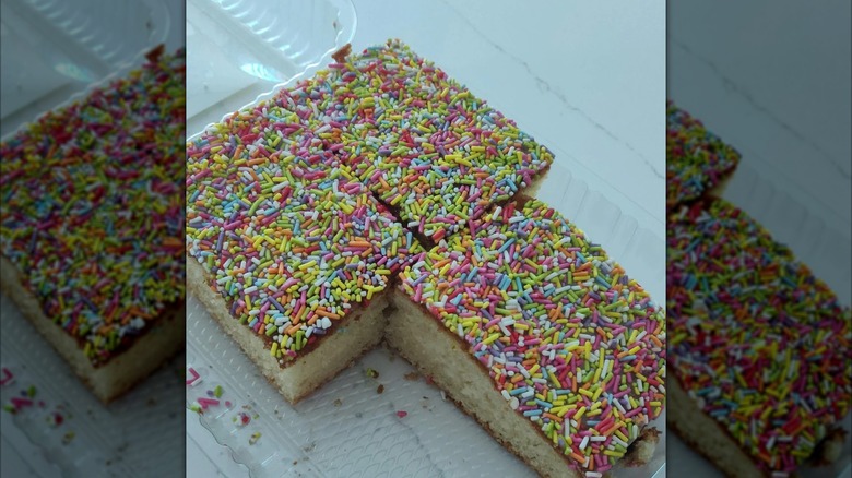 Open packet of School cake with one slice missing, mirrored image