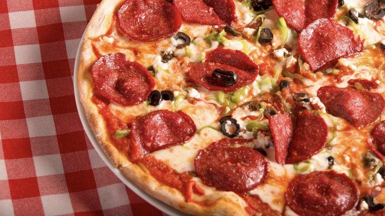 Tavern-style pizza on checkered tablecloth