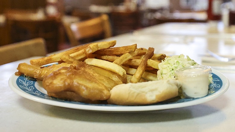 Plate of fried fish and french fries and biscuit