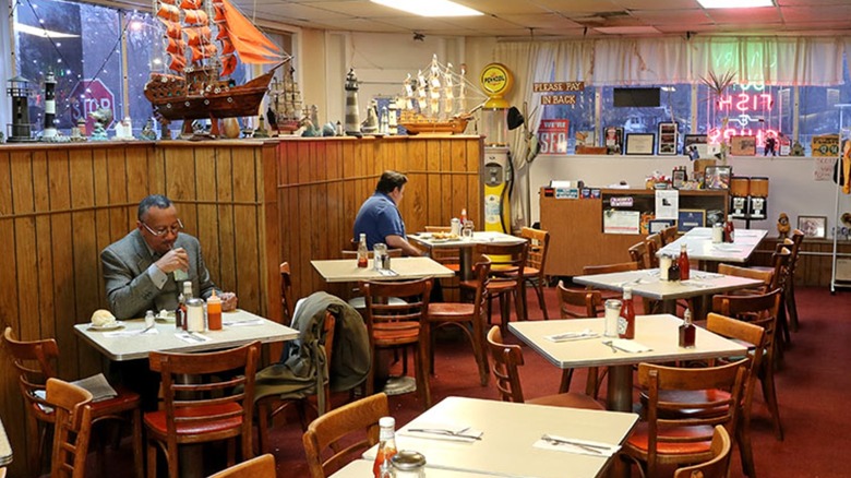 Interior of Scotty's with wooden paneling and model ships