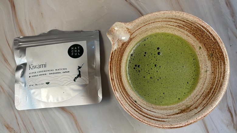 Matcha in beige chawan next to Matchaful Kiwami Matcha bag