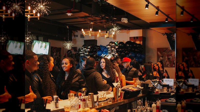 People gathered around a bar at Legion