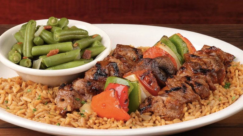 Steak Kabob skewers on a bed of rice