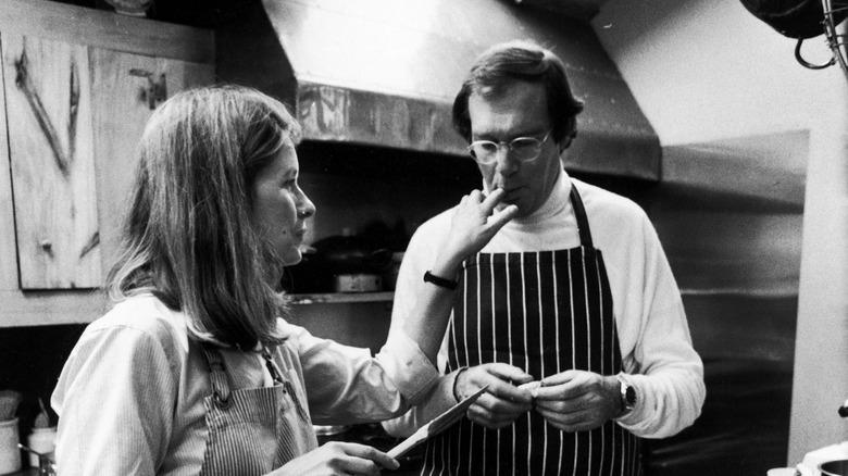 Black and white photo of Martha and Andy Stewart baking