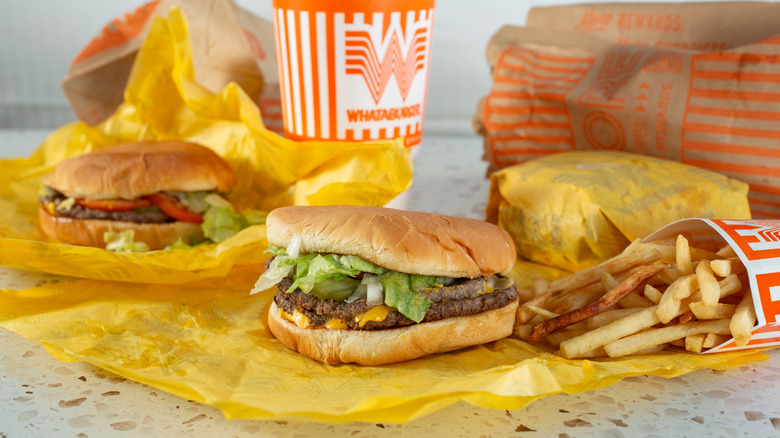 Three sandwiches, an order of fries, and a drink from the chain Whataburger