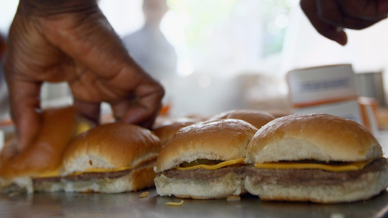 A hand picking up a White Castle Slider