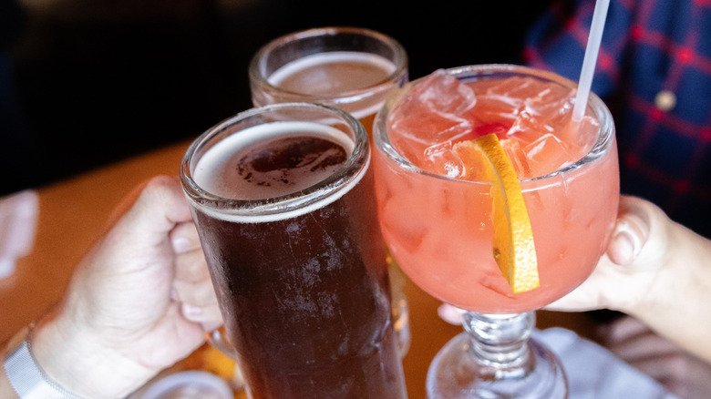 Diners toasting beer and cocktails at texas roadhouse