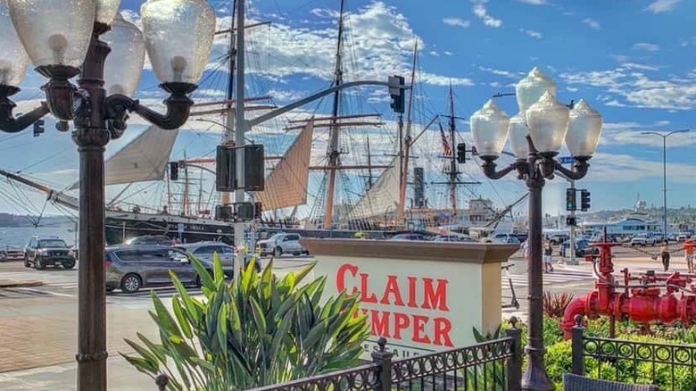 Exterior sign for Claim Jumper with large ship in the background