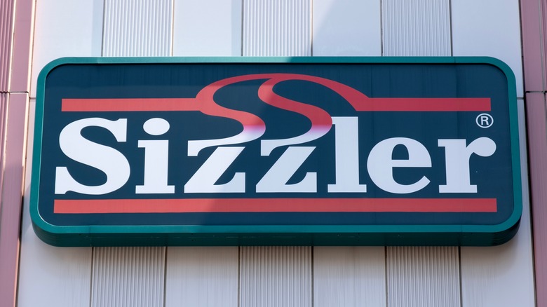 Exterior view of a Sizzler sign on front of a building