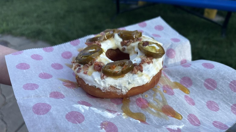 Hot honey jalapeño popper donut on polka dot paper wrapper.