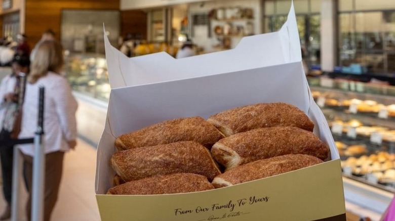 open Porto's Bakery box filled with pastries with counter in the background