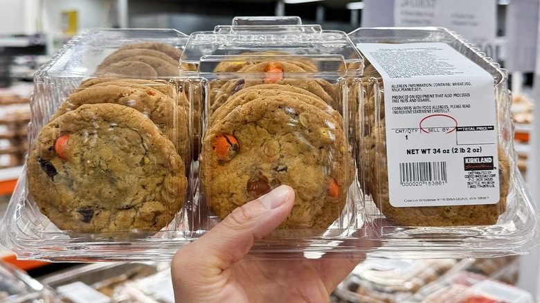 Hand holding a box of cookies at a Costco Bakery