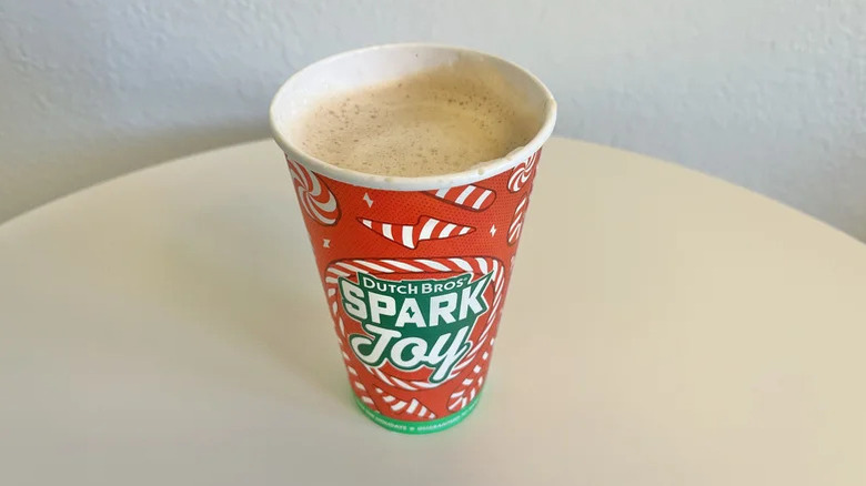 Dutch Bros 2% milk latte in a paper cup